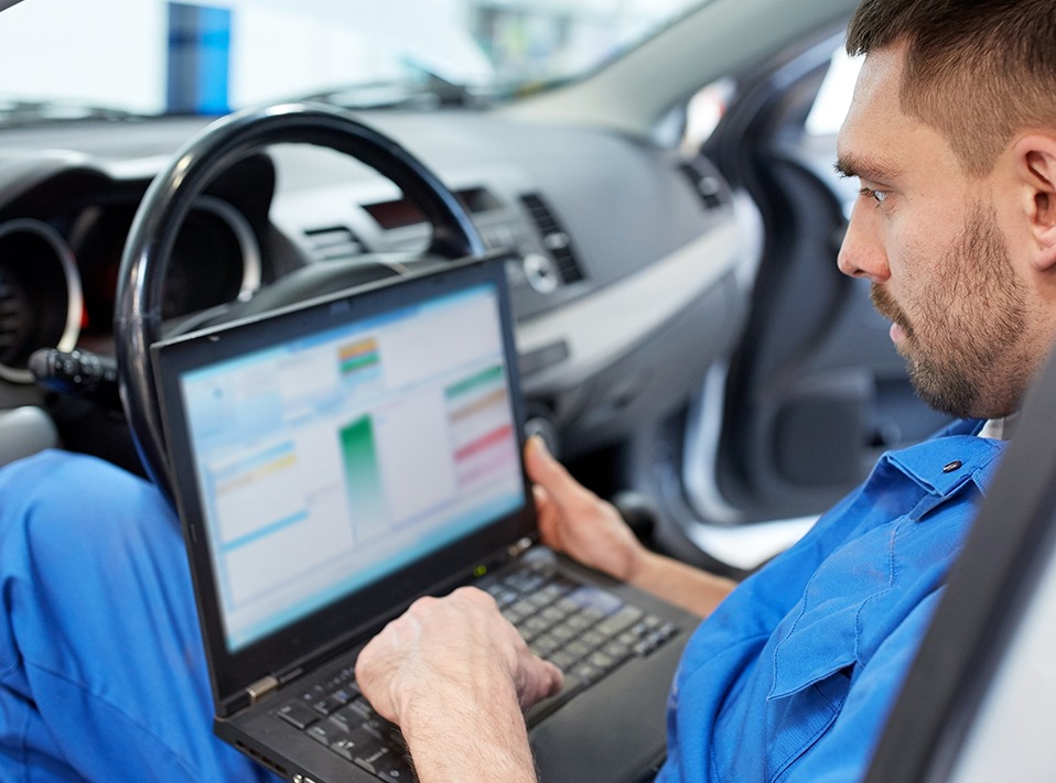 Mechanic looking over computer statistics - Car Remapping Loughborough